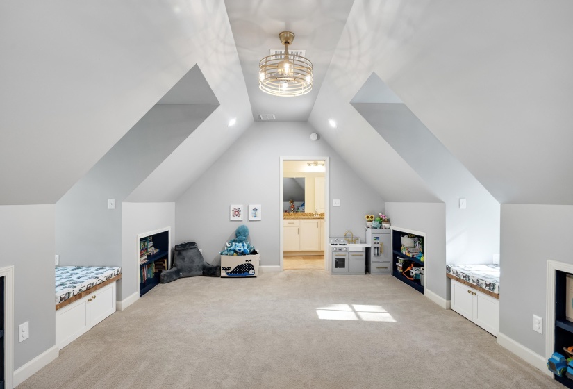 Bonus room featuring light carpet and baseboards