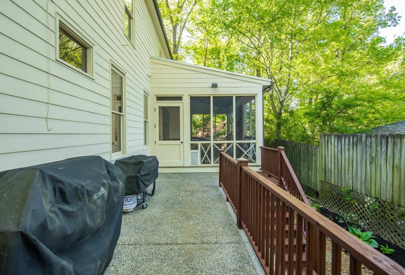 Fenced backyard featuring a sunroom, area for grilling, and a patio area