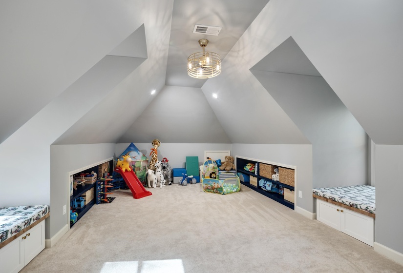 Rec room with light colored carpet and a chandelier