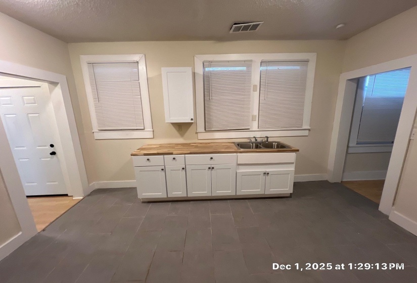 Full bathroom featuring dark wood finished floors, vanity, and a textured ceiling