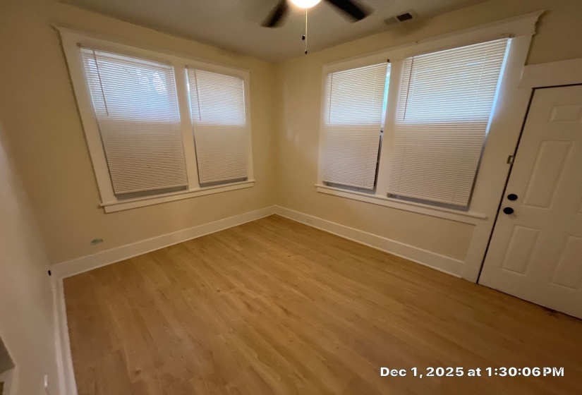 Empty room with light wood finished floors and ceiling fan