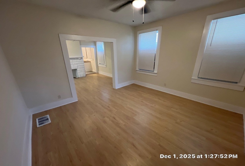 Unfurnished room featuring light wood-type flooring and a ceiling fan