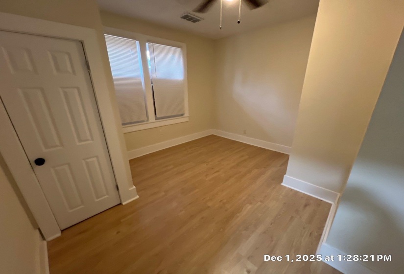 Empty room featuring light wood-style floors and ceiling fan