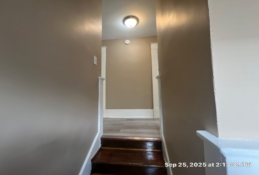 Stairs featuring baseboards and wood finished floors