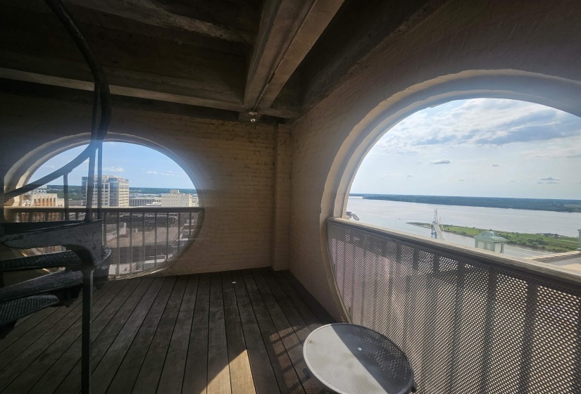 Balcony with a water view and a city view