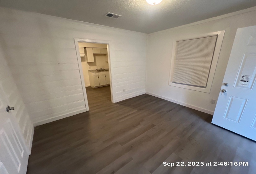 Unfurnished bedroom featuring dark wood finished floors and a textured ceiling