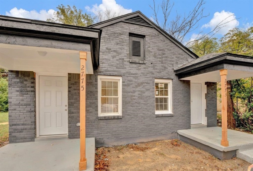 View of front of home featuring brick siding and a porch