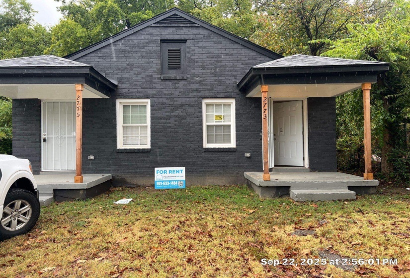 View of front of property featuring brick siding and a front yard