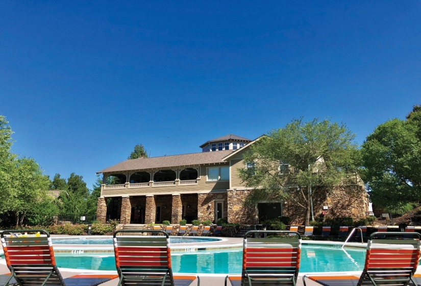 Community pool with a patio, a hot tub, and a balcony