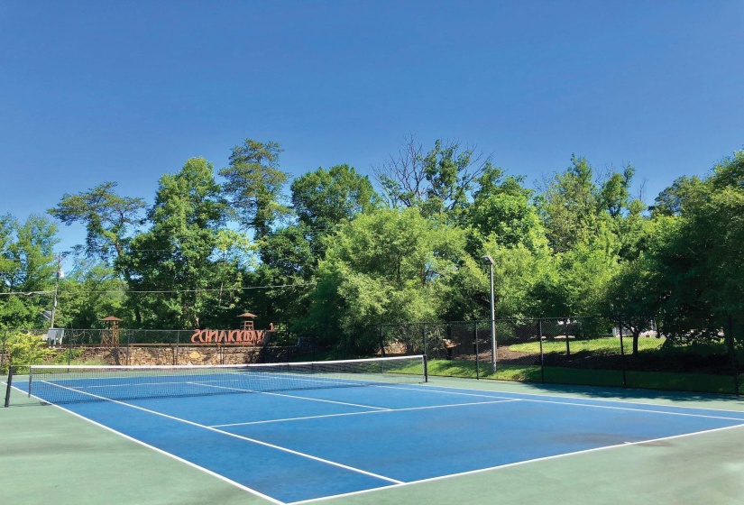 View of tennis court featuring community basketball court