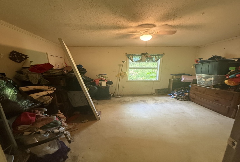 Bedroom featuring a textured ceiling and a ceiling fan