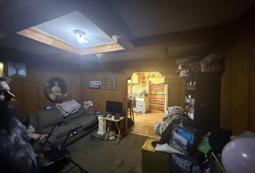 Living area with wooden walls and arched walkways