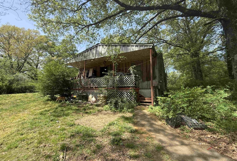 View of front of house featuring view of wooded area