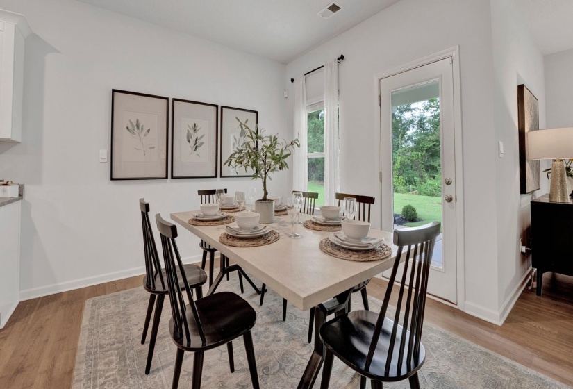 Dining space with light wood-style floors and baseboards