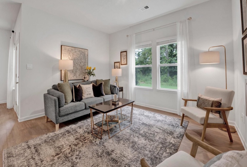 Living area featuring light wood finished floors and baseboards