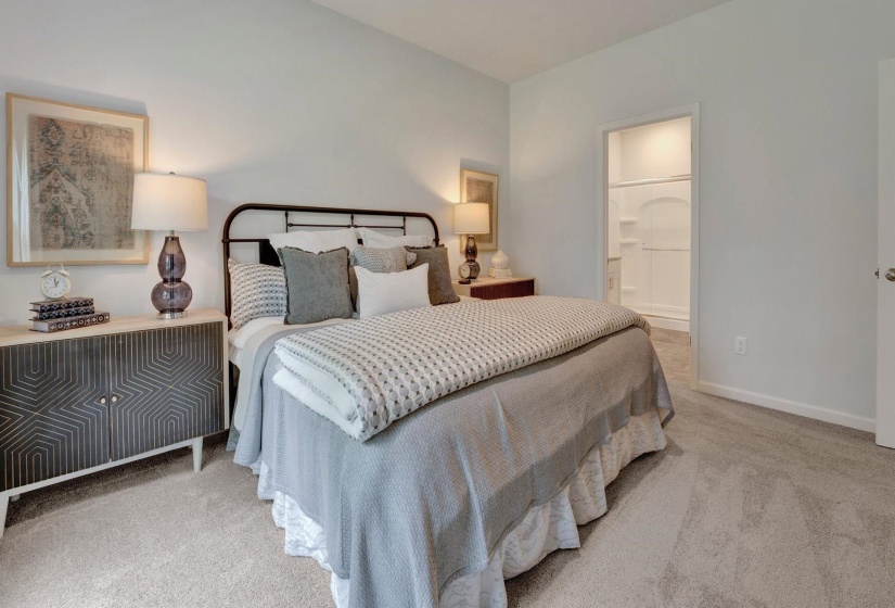 Bedroom with light colored carpet and ensuite bath
