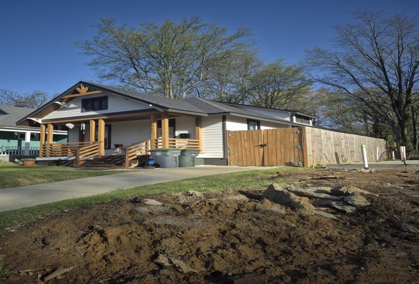 View of front of home with covered porch and a gate