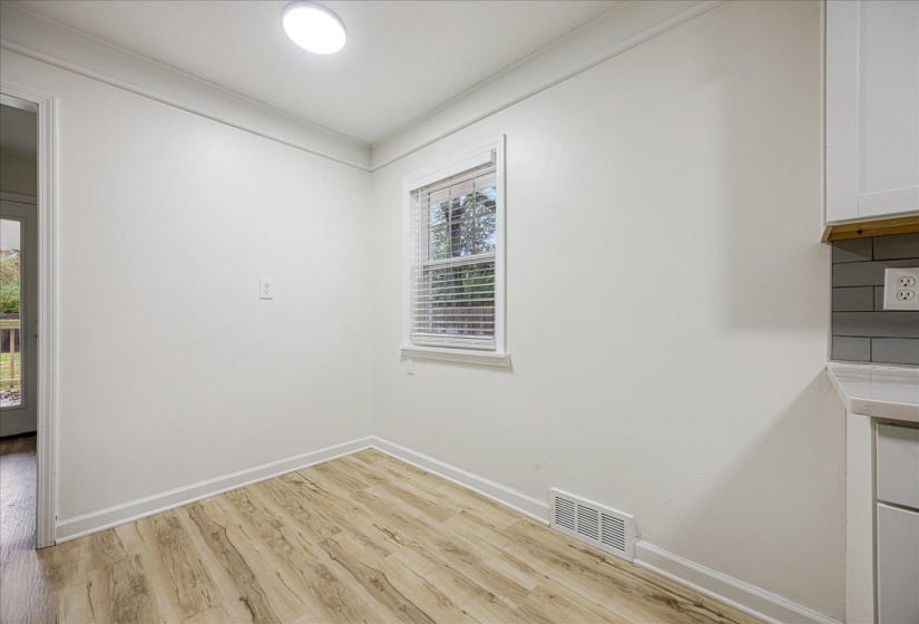 Unfurnished dining area featuring light wood finished floors and crown molding