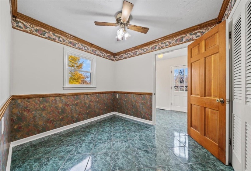 Unfurnished room with a wainscoted wall, ornamental molding, ceiling fan, and wallpapered walls