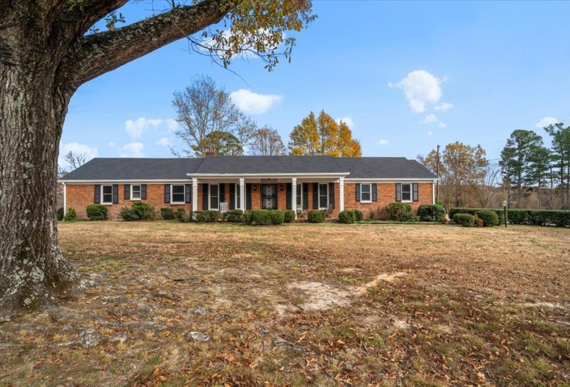 Charming curb appeal welcomes you to this well-maintained home, featuring a classic exterior, mature surroundings, and a peaceful small-town setting