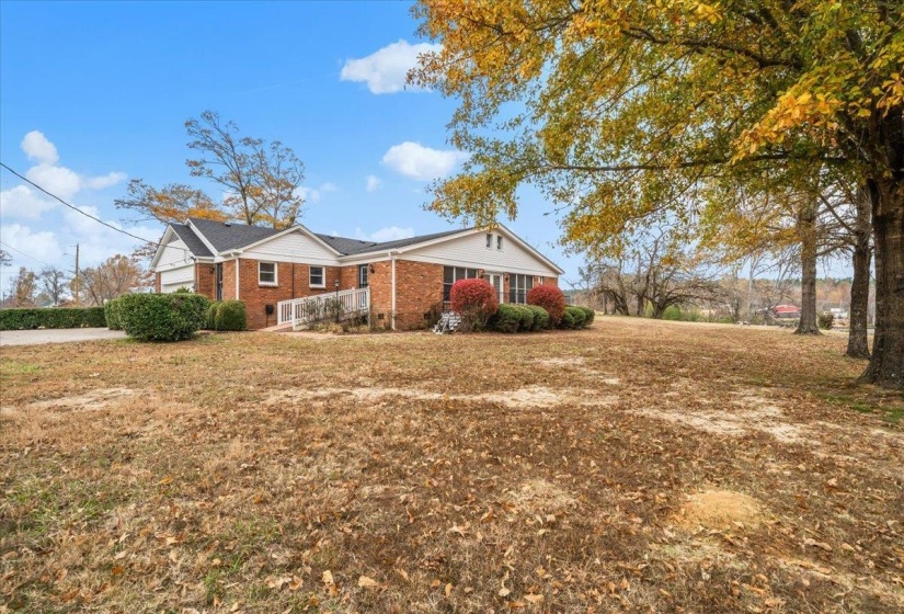 View of front of house with a front yard and brick siding