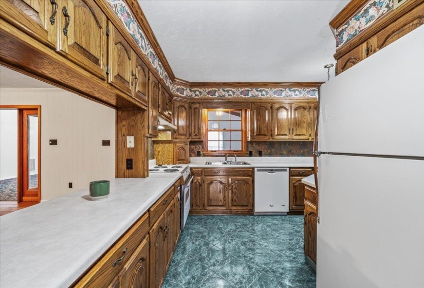 Well-organized kitchen with ample storage and workspace, ideal for meal preparation and family gatherings.