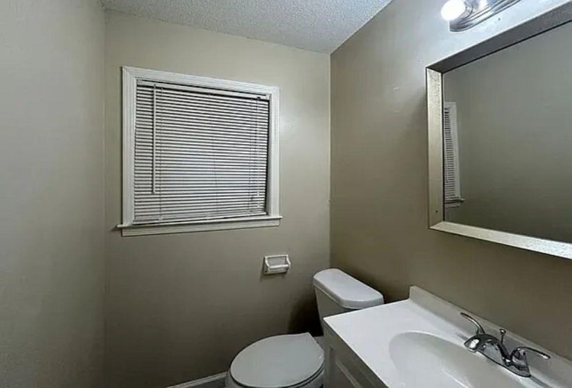 Half bathroom featuring vanity and a textured ceiling