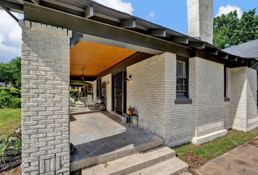 Entrance to property featuring brick siding and a chimney
