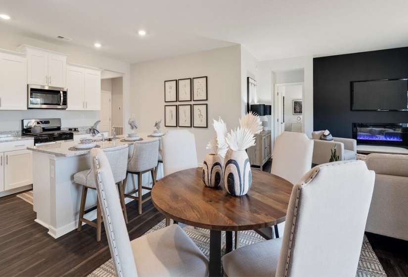 Dining room featuring dark wood-style floors and recessed lighting