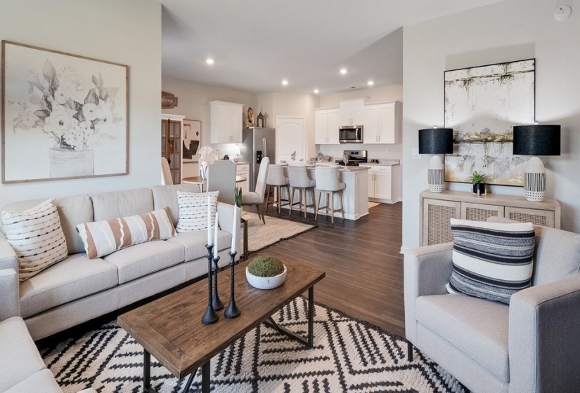 Living room featuring dark wood-type flooring and recessed lighting