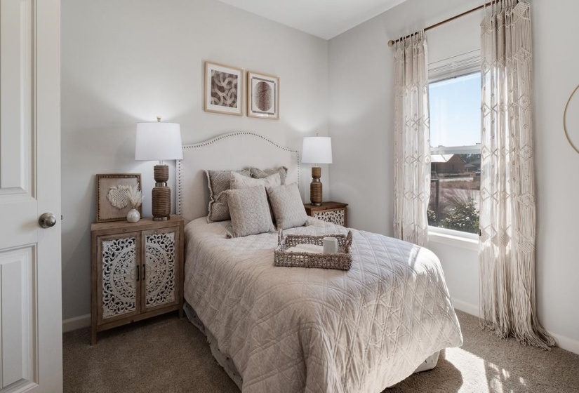 Carpeted bedroom featuring baseboards