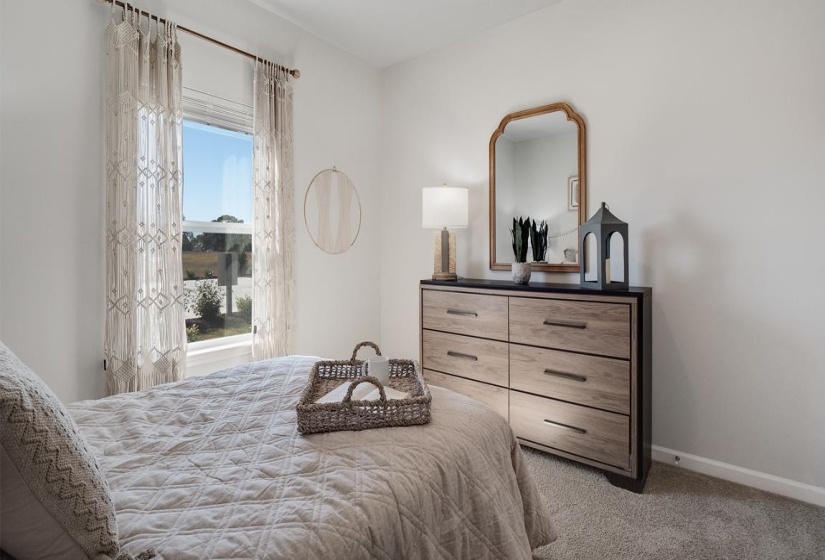 Bedroom featuring light colored carpet and baseboards