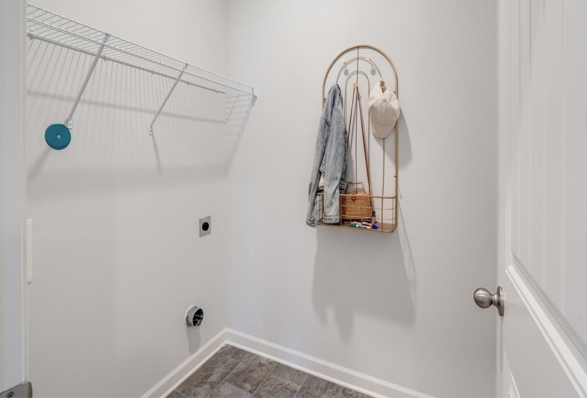 Washroom featuring baseboards and electric dryer hookup