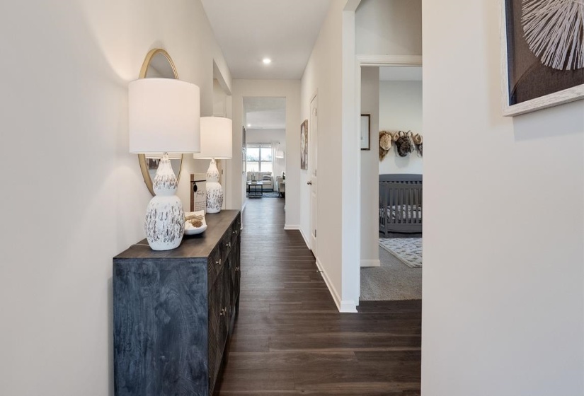 Corridor with dark wood-style floors and recessed lighting