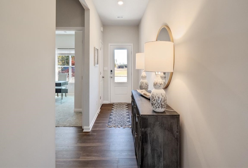 Doorway with baseboards and wood finished floors