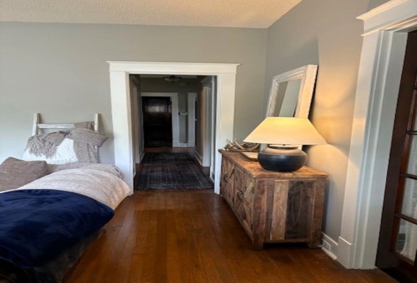 Bedroom featuring dark wood finished floors and a textured ceiling