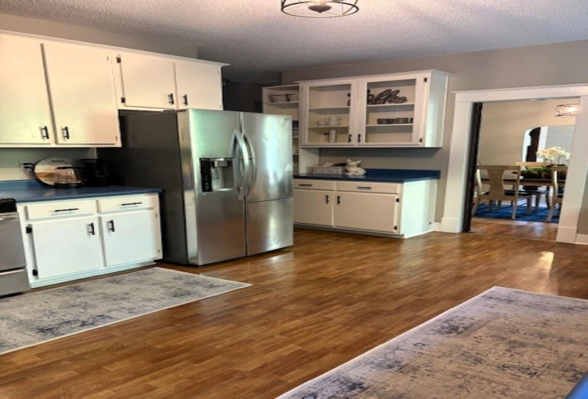 Kitchen featuring dark countertops, white cabinetry, and a textured ceiling