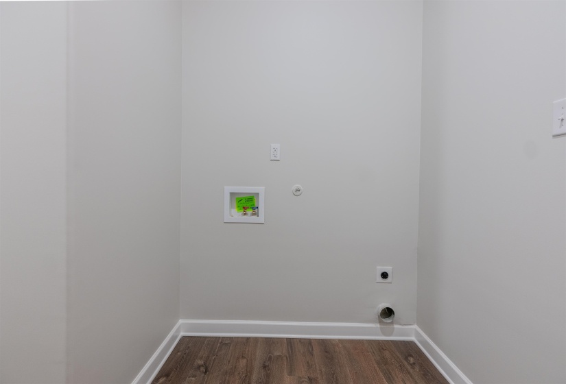 Laundry room featuring hookup for a washing machine, dark hardwood / wood-style floors, and electric dryer hookup