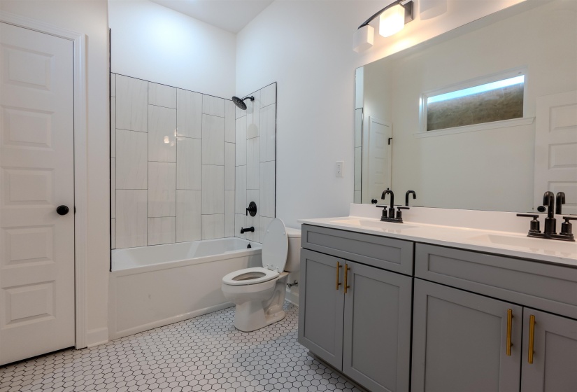 Full bathroom featuring tile patterned floors, toilet, vanity, and shower / bathing tub combination