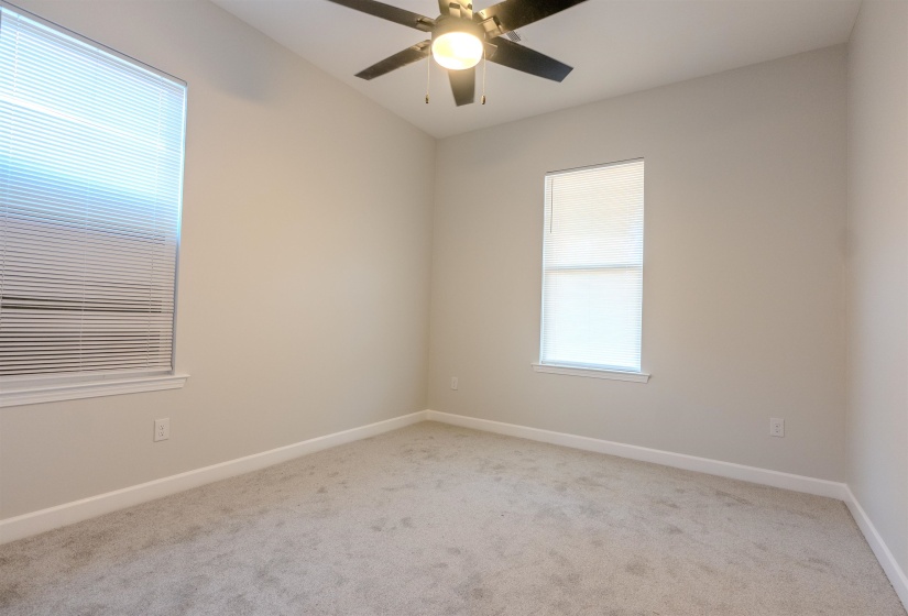 Spare room with ceiling fan and light colored carpet
