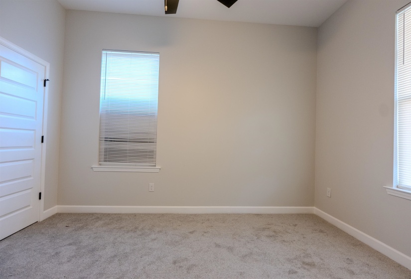 Unfurnished room with ceiling fan and light colored carpet
