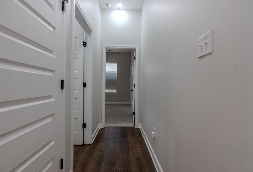 Corridor with dark hardwood / wood-style floors