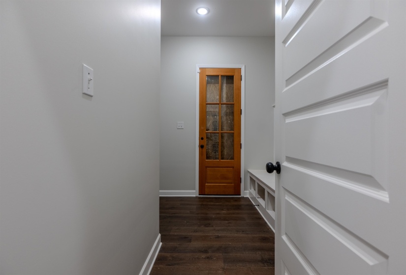 Doorway with dark wood-type flooring