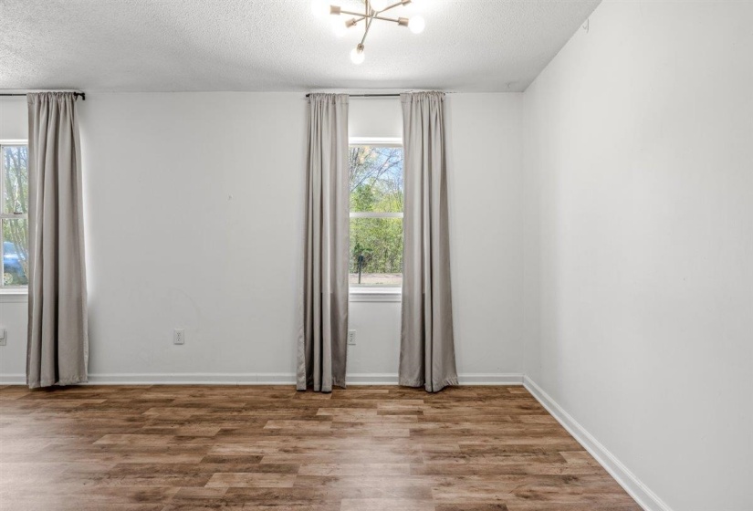 Empty room with wood finished floors and a textured ceiling