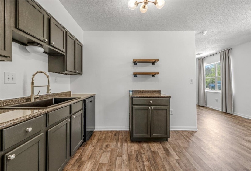 Kitchen featuring open shelves, dark wood-style floors, a textured ceiling, dishwasher, and dark wood finish cabinetry