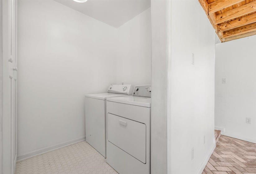 Laundry area featuring washing machine and dryer and baseboards