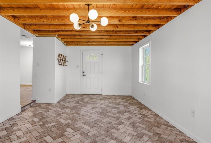 Foyer featuring baseboards and wood ceiling