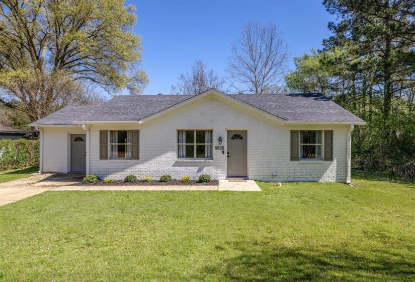 Single story home featuring a front lawn, brick siding, and a shingled roof