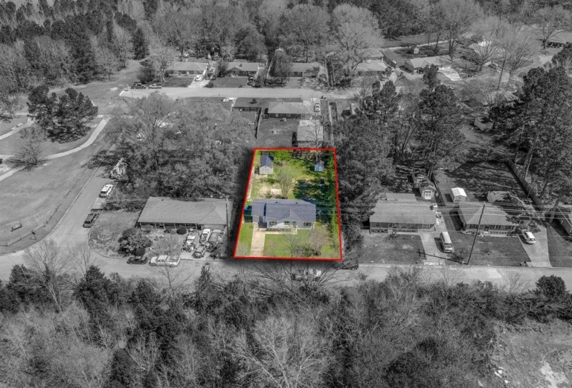 Aerial view of residential area with property parcel outlined