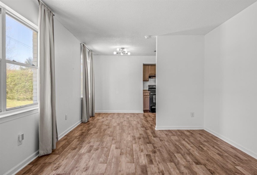 Unfurnished room featuring a textured ceiling and light wood finished floors